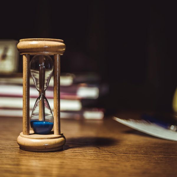 Timer and notebook on a wooden desk